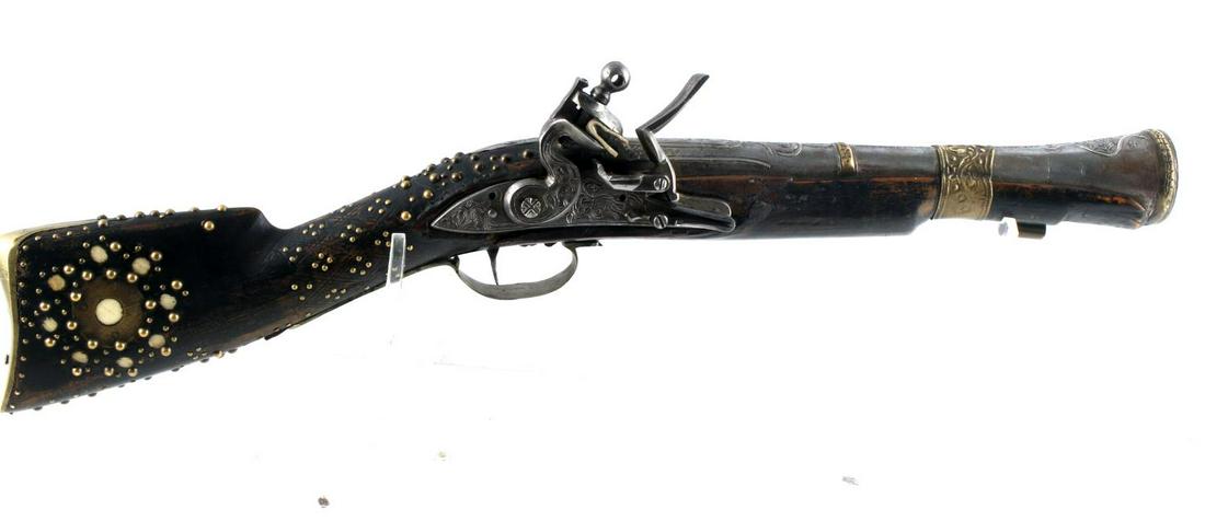 MEDITERRANEAN FLINTLOCK BLUNDERBUSS PISTOL: Mediterranean or even Middle Eastern brass tacked with none inlay, working action, no ramrod, etches barrel, length overall 22 inches. No International shipping.