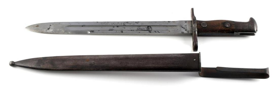 MODEL 1892 KRAG BAYONET US 1899 MARKED W SCABBARD: US Model 1892 Krag bayonet. Marked 1899 and US. Comes with scabbard. Features some spotting and dents in wooden grip. Measures 16 inches overall.