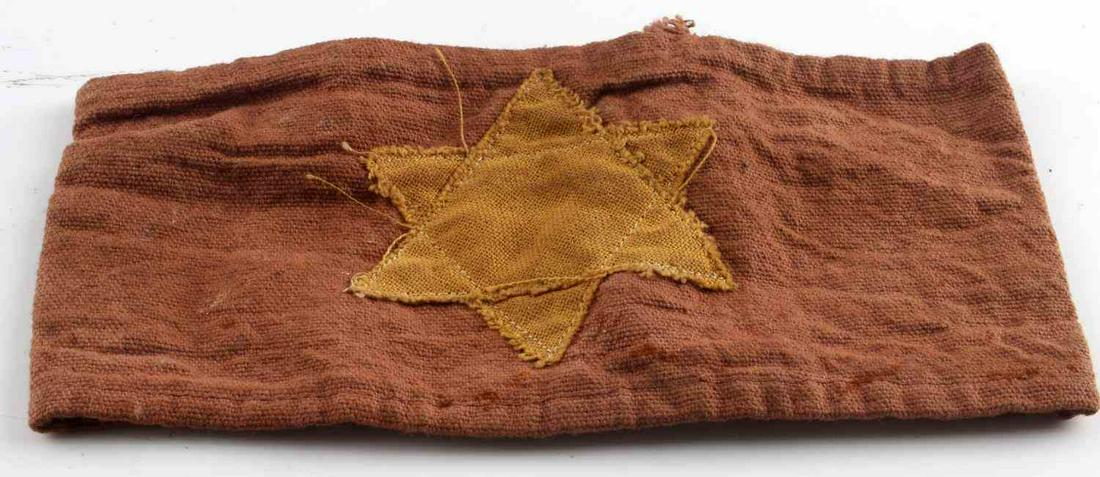WWII GERMAN THIRD REICH JEWISH HOLOCAUST ARMBAND: Third Reich Jewish arm band. Stitching on the Star of David fluoresces. Very good condition. Measures 3 3/4 inches.