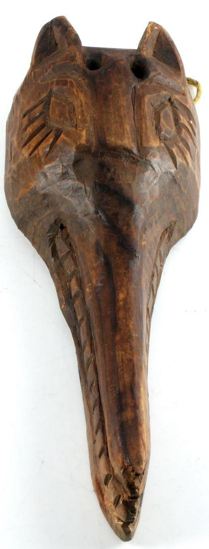 PACIFIC NORTHWEST HAND CARVED WOODEN WOLF MASK: Pacific Northwest hand carved wooden wolf display mask. Possibly carved by the Haida or Tlingit tribes in the late 19th or early 20th century. Has a hemp-type cord on the back for hanging. Measures ap