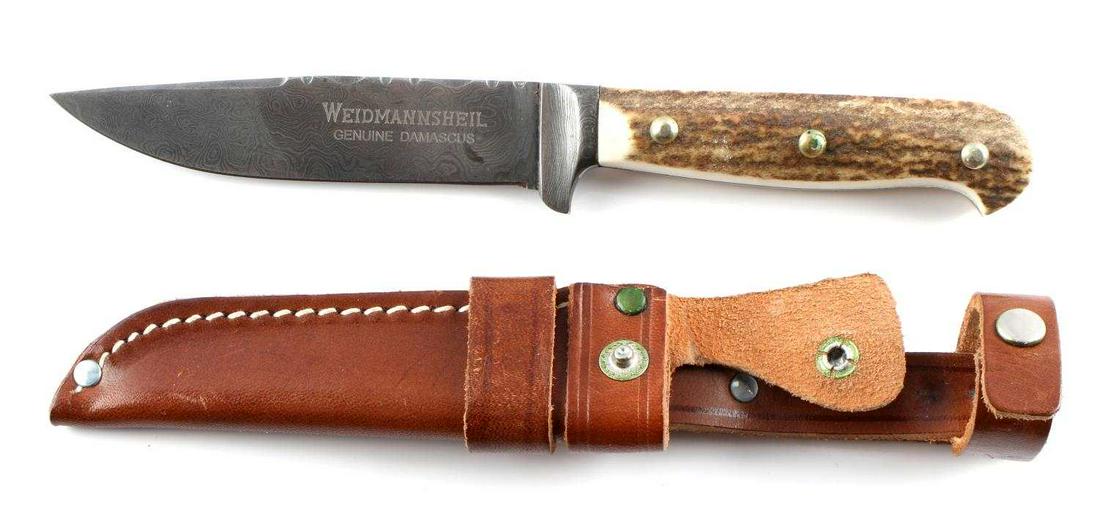 WEIDMANNSHEIL GENUINE DAMASCUS CLIP POINT KNIFE: Genuine Damascus steel blade with antler grip. Measures 8 1/4 inches. Comes with nice leather scabbard. Very good condition.
