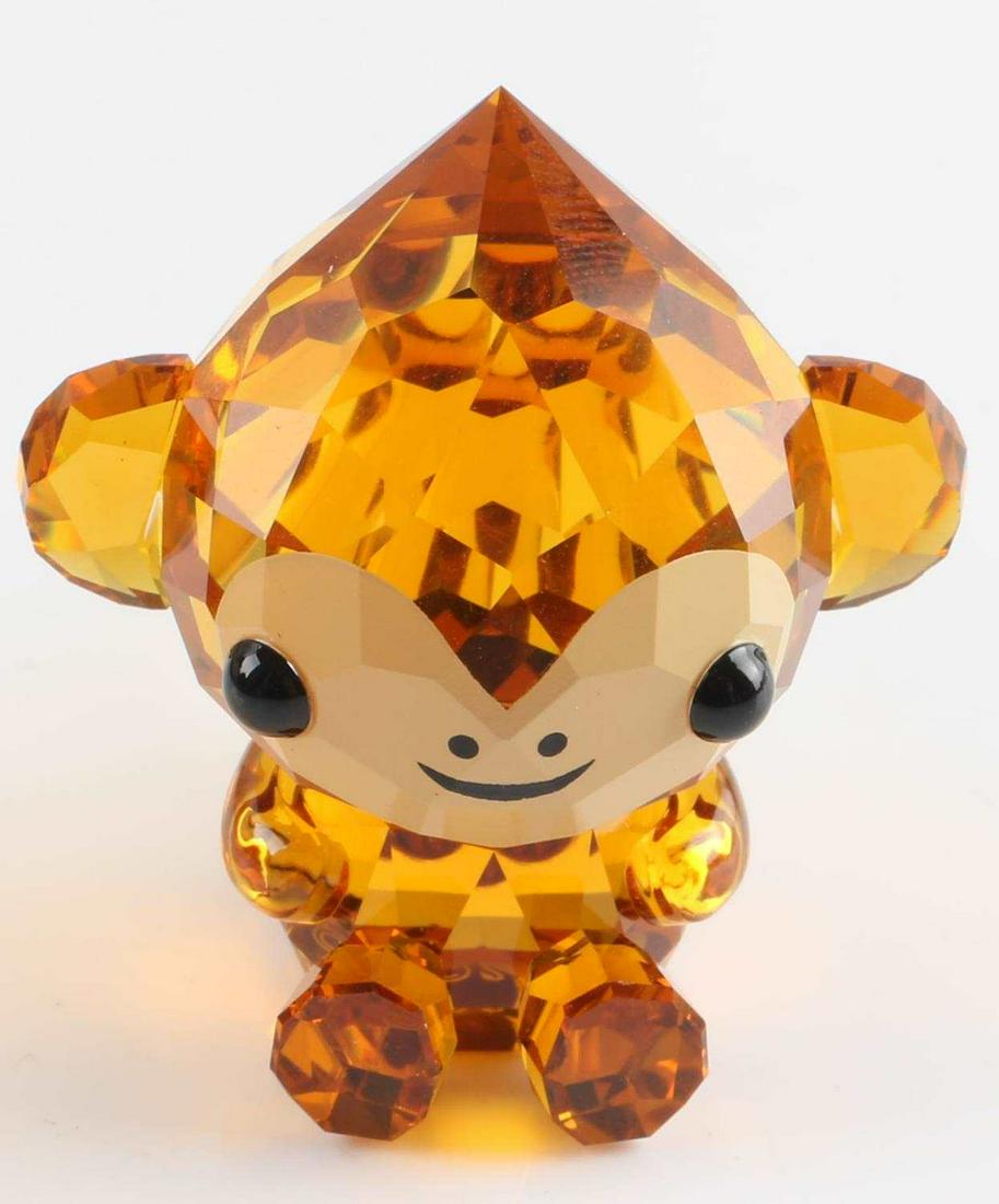 SWAROVSKI CRYSTAL ZODIAC CHEERFUL MONKEY FIGURE: Designed by Hiroshi Yoshii and crafted in brown crystal with printed details, year of the Monkey figure, Swarovski hallmarked, no chips, repairs or box. 1 1/4 x 1 1/4 inches (3.5cm x 3.5cm)