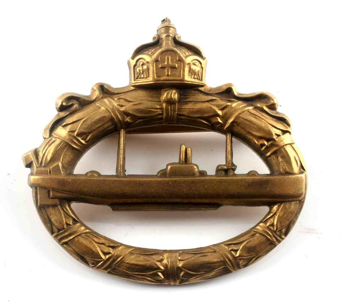 WWI IMPERIAL GERMAN BRONZE U BOAT BADGE: WWI Imperial German bronze u-boat badge. Crown to top with oak leaf wreath around cut-out u-boat to center. Flat horizontal pin with 'c' catch. Reverse marked "WALTER SCHOTT fec.". 2 X 2 inches. Good