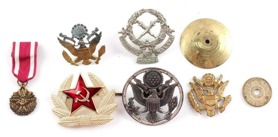 WWII & LATER LOT CAP BADGES RUSSIAN MALAYSIAN US: Lot includes: small service medal, 3 cap eagles, Federation of Malaya Police, and Russian badge. Condition varies.