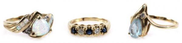 LOT LADIES 10K & 14K OPAL DIAMOND & SAPPHIRE RINGS: LOT LADIES 10K & 14K OPAL DIAMOND & SAPPHIRE RINGS Consisting of 1 - 10K triangular cut opal & diamond ring, 1 - 14K pear cut blue topaz & diamond ring and 1 - 14K round cut diamond & sapphire ring. G