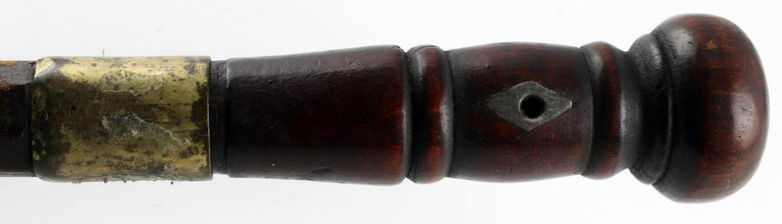 CIVIL WAR ERA WOODEN SWORD CANE W BRASS & PEWTER: Civil war era wooden sword cane with inlaid pewter on the handle and brass on the heel. The blade measures 9 1/4 inches long, the cane measures 35 5/8 inches in total. Features a period repair from ab