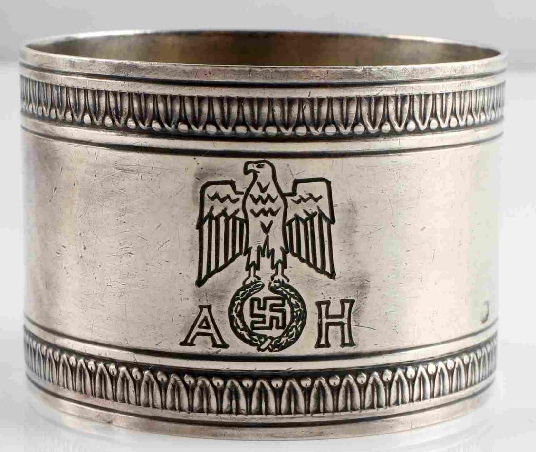 WWII GERMAN ADOLF HITLER FORMAL SILVER NAPKIN RING: WWII German Adolf Hitler formal silver napkin ring. Stamped "HBCIE" and "825" on the outside of the ring. Features Hitler's insignia on the front of the of the ring with some nice detail. Measures app