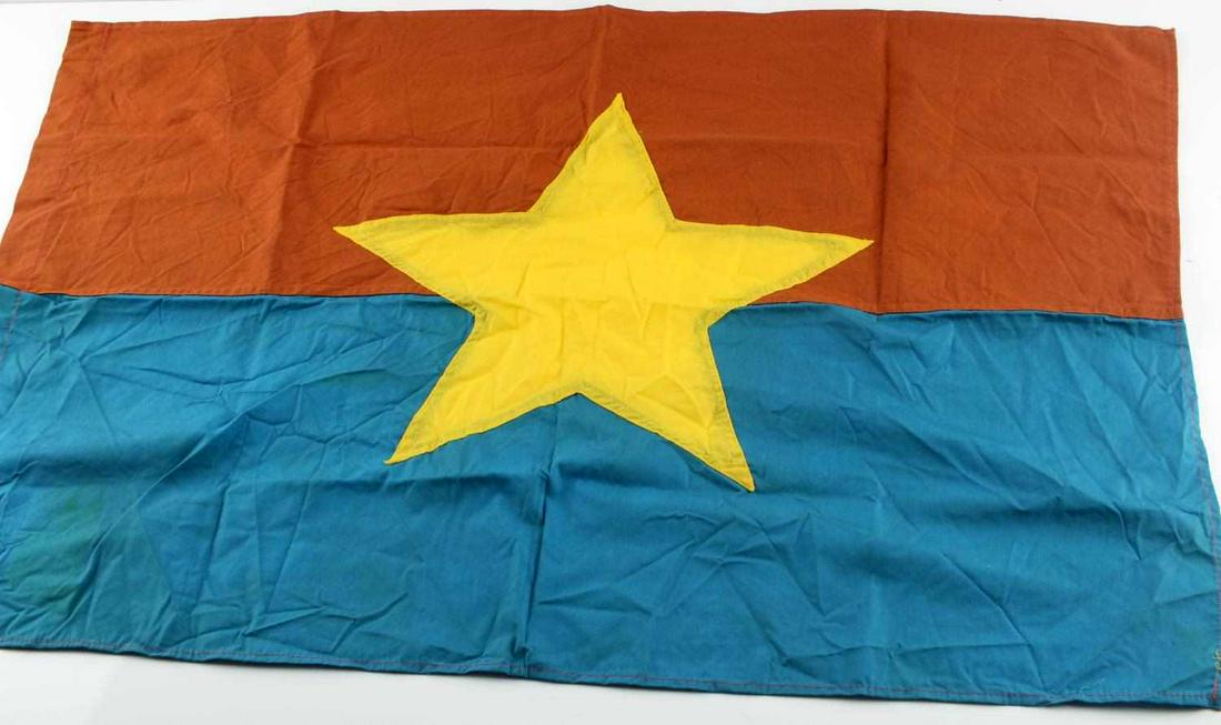 VIETNAMESE VIET CONG COMBAT STAR BATTLE FLAG: Vietnam Era Viet Cong VC Combat Battle Flag. Measures 30 X 20 1/2 inches. Has a five armed yellow cloth star in the center of the flag. Double sided. Three piece machine sewn blue, orange and yellow c