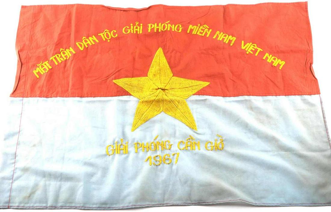 VIETNAM CIVIL WAR ERA VIETCONG COMBAT BATTLE FLAG: Vietnam Civil War Era Viet Cong VC Combat Battle Flag. Measures 29 X 20 3/4 inches. Has a machine embroidered yellow star in the center. The VC writing above and below reads ‘Mat Tran Dan Toc Giai P