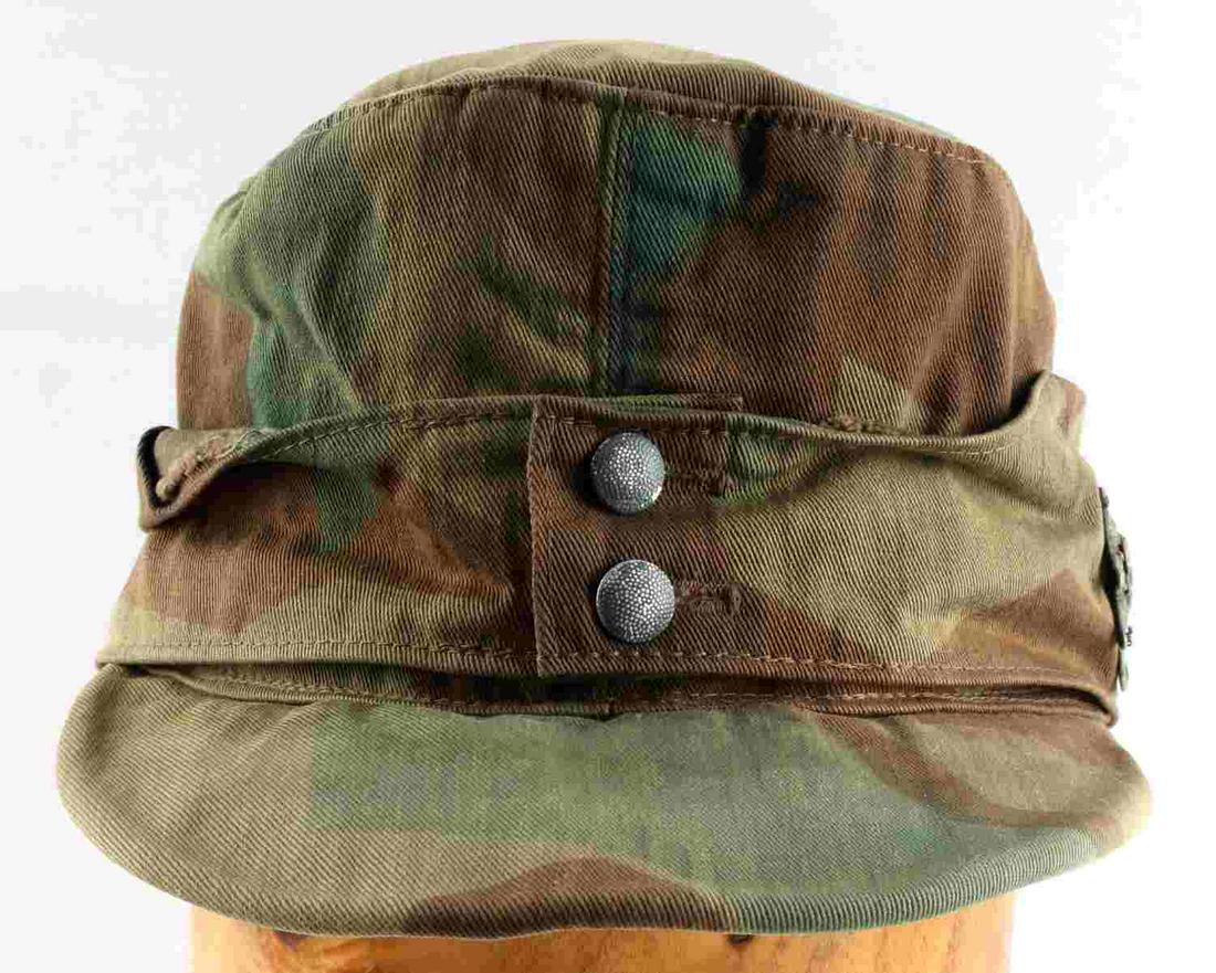 WWII THIRD REICH ARMY M-43 MOUNTAIN CAMO CAP: German WWII Army M-43 Mountain Troop Camouflage Cap. This is the splinter camouflage pattern. There is a metal edelweiss sewn on the left side. The interior has a grey cotton lining. It is maker marke