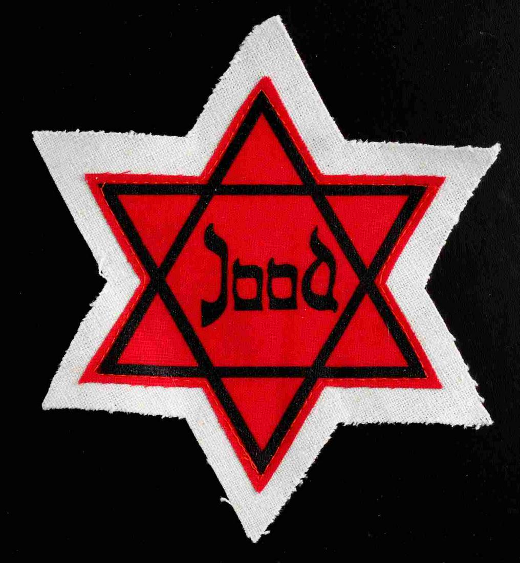 WWII JEWISH JAAD JUDEN CONCENTRATION CAMP STAR: WWII Jewish Jaad Juden Concentration Camp Star. Measures 5 3/8 X 6 inches. The front shows a red Jewish star with a black outline. It reads ‘Jaad’. Two piece machine sewn cotton construction. Unau