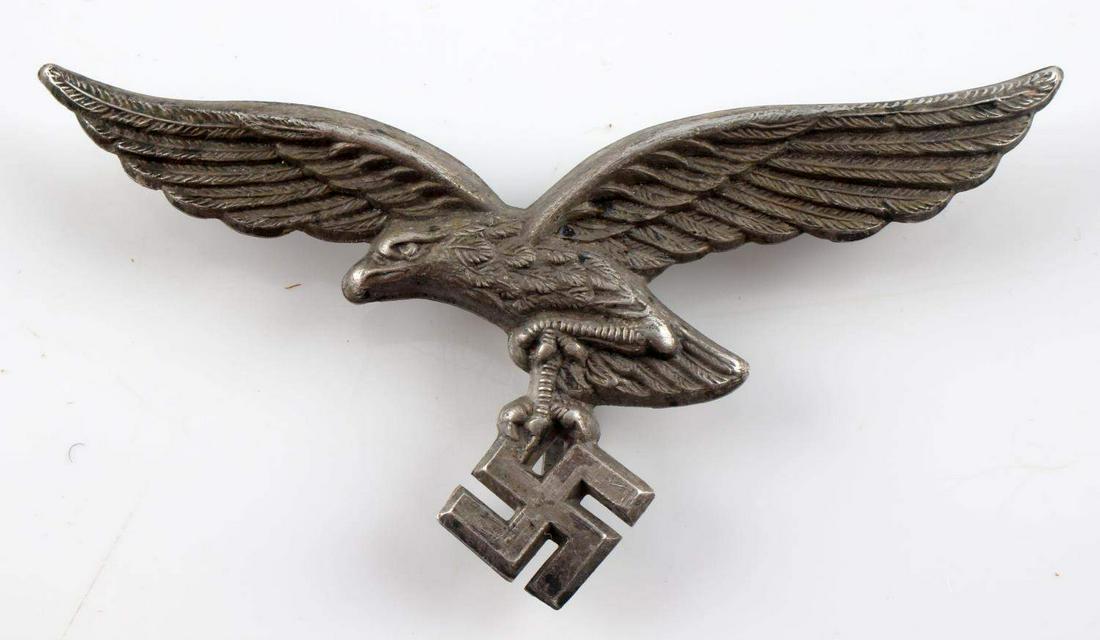 WWII GERMAN LUFTWAFFE AFRIKA PITH HELMET EAGLE: German WWII Luftwaffe Afrika Korps Pith Helmet Eagle & Shield. The flying eagle clutching a swastika in his talons measures 2 5/8” wide by 1 3/8” tall. Has three flat prongs on the reverse side. D