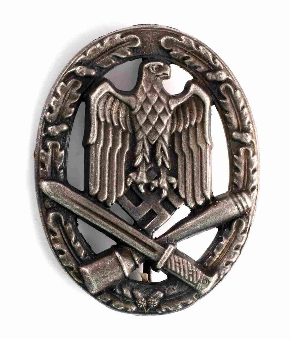WWII GERMAN ARMY SILVER GENERAL ASSAULT BADGE: WWII German Army Silver General Assault badge. The front shows a German eagle clutching a swastika in his talons in the center with a crossed grenade and bayonet below. All three are surrounded by an 