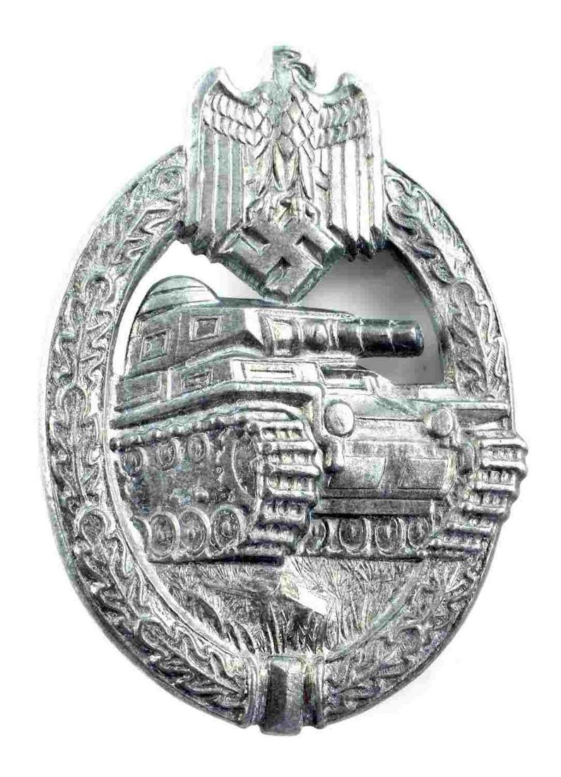 WWII GERMAN THIRD REICH PANZER ASSAULT BADGE: German WWII Army Silver Tank Assault Badge. The front shows a tank in the center with a German eagle clutching a swastika in his talons at the top. Both are surrounded by an oval oak leaf wreath. The