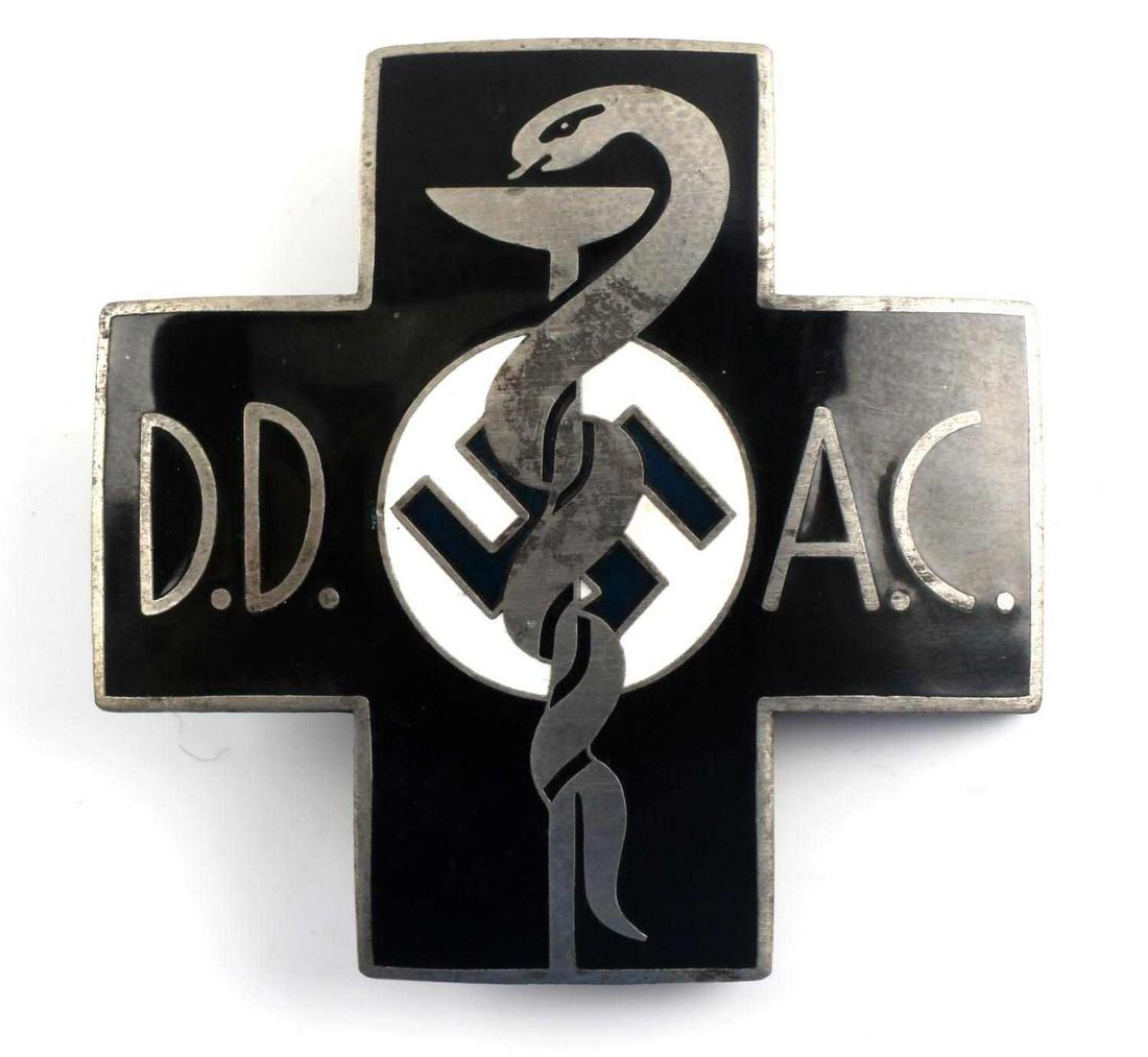 WWII GERMAN MEDICAL DD AC DOCTORS BREAST BADGE: Measures 1 7/8 X 1 7/8 inches. Obverse shows a snake wrapped around a beaker and reads ‘DD AC’. Reverse maker marked ‘Carl Poellath Schrobenhausen’. Numbered ‘68’. Thin vertical safety pin