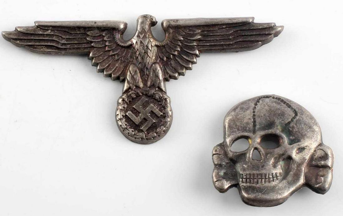WWII GERMAN WAFFEN SS OFFICERS CAP EAGLE & SKULL: The front shows a Waffen SS eagle clutching a swastika in his talons. It measures 2 11/16 X 1 1/4 inches. The skull and cross bones measures 1 1/8 X 1 1/8 inches. They are maker marked ‘RZM’. Both