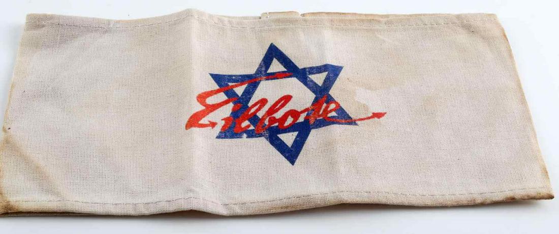 WWII THIRD REICH JEWISH CONCENTRATION CAMP ARMBAND: German WWII Jewish Star Eilbolte Concentration Camp Arm Band. Measures 8 7/8” wide by 4 1/4” tall. The front shows a blue Jewish star in the center and reads ‘Eilbolte’ (Courier). One piece ma