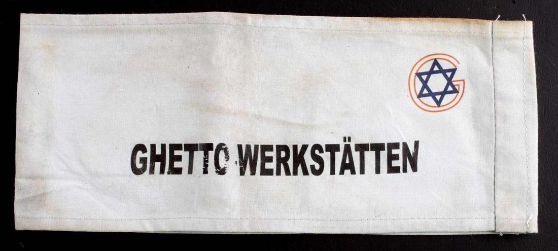 WWII JEWISH WERKSTATTEN CONCENTRATION CAMP ARMBAND: WWII Jewish Ghetto Werkstatten Concentration Camp armband. Measures 9 3/16 X 3 3/4 inches. The front shows a Jewish star in the upper right handle. It reads ‘GHETTO WERKSTATTEN’. One piece machine