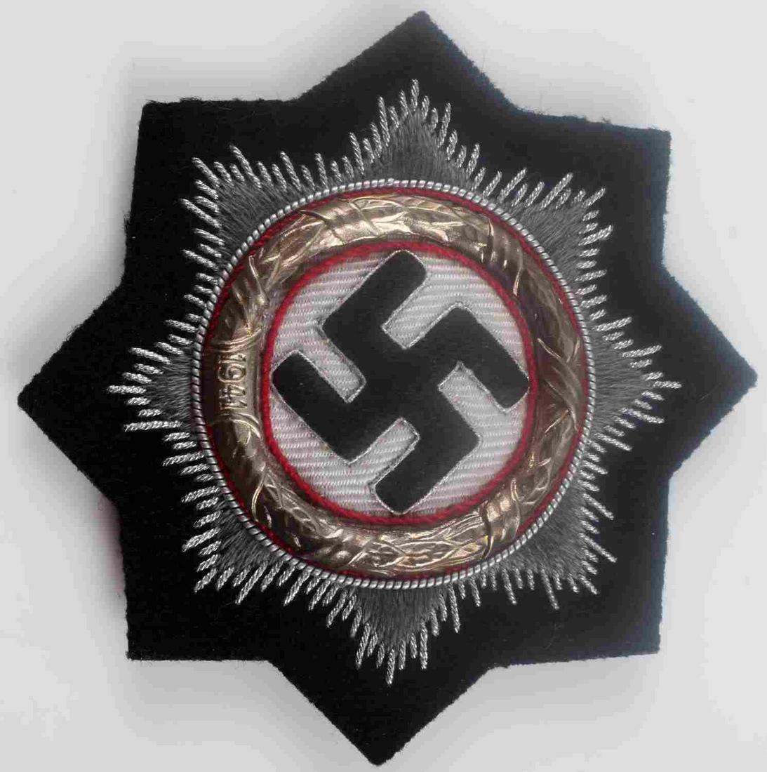 WWII GERMAN WAFFEN SS PANZER GERMAN CROSS IN CLOTH: German WWII Waffen SS Panzer German Cross in Gold in Cloth. Measures 3 1/16” in diameter. The front shows a swastika in the center surrounded by a round brass oak leaf wreath dated ‘1941’ at the