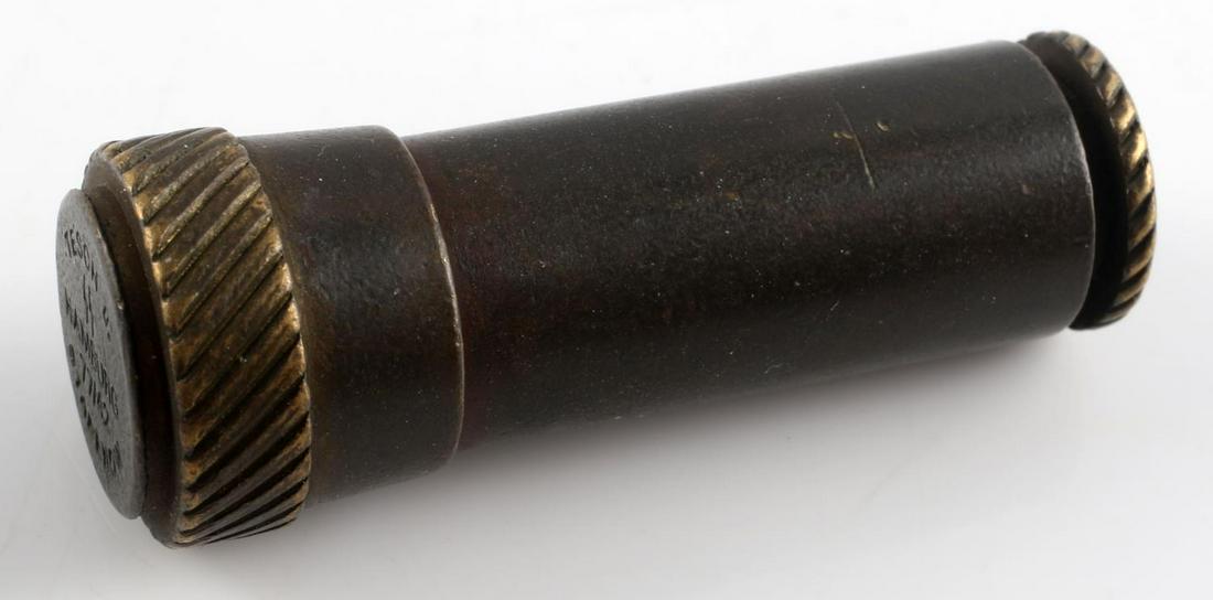 WWII GERMAN THIRD REICH SS CYANIDE PILL CONTAINER: German WWII Waffen SS Cyanide Capsule Container. Measures 1 5/8” long by 5/8” in diameter. The top of the lid is marked ‘TESCH u. SS HAMBURG 77/42 STABENOW’. The bottom portion is stamped with