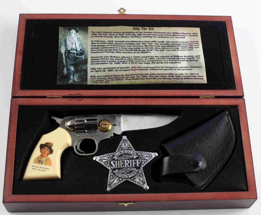BILLY THE KID FOLDING GUN KNIFE & SHEIRFFS BADGE: Billy the Kid folding gun-knife and Sheriff's badge set. Set includes the knife, a sheath for the knife, and a Sheriff's badge. Comes in a collectible wooden Billy the Kid box. Knife measures approxim