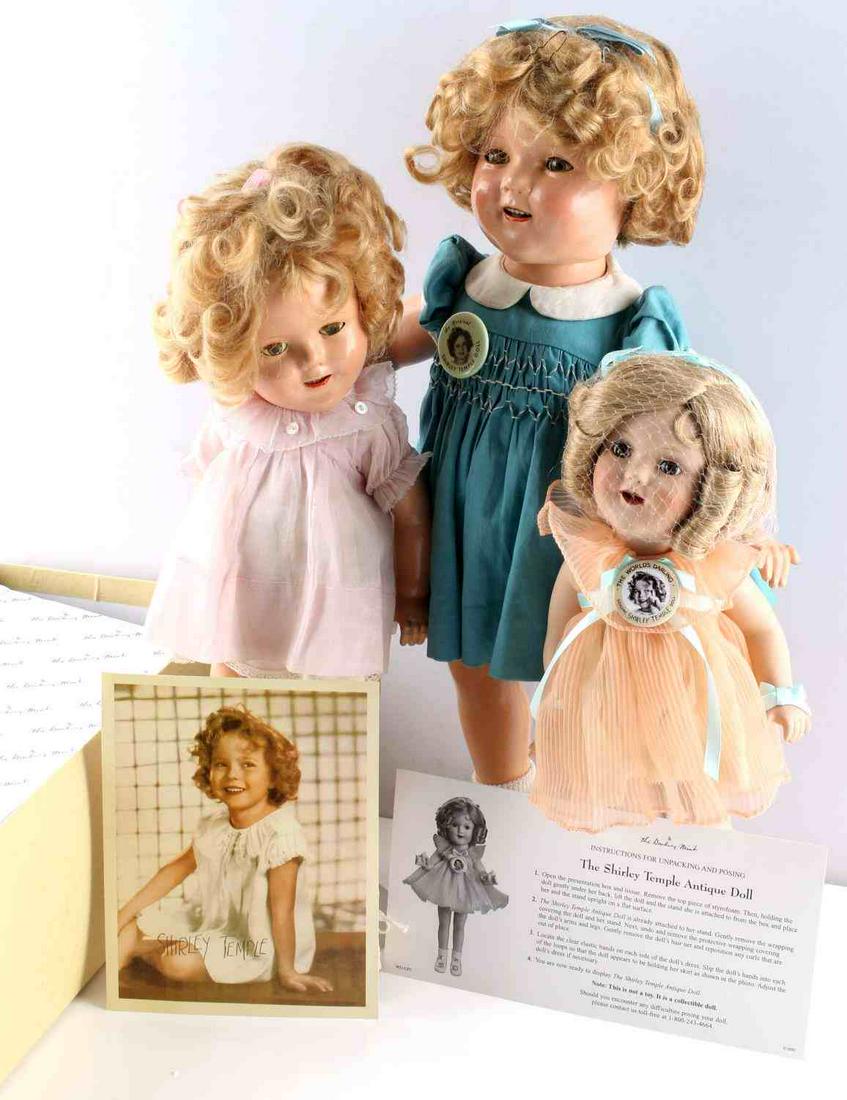 2 SHIRLEY TEMPLE ANTIQUE DOLL 1 DANBURY MINT W COA: Lot of 3 Shirley Temple dolls. Two (18 inch & 15inch) are 1930's-1940's IDEAL composition dolls, marked on back of neck, in original garb with full moving appendages and blinking eyes. In good conditi