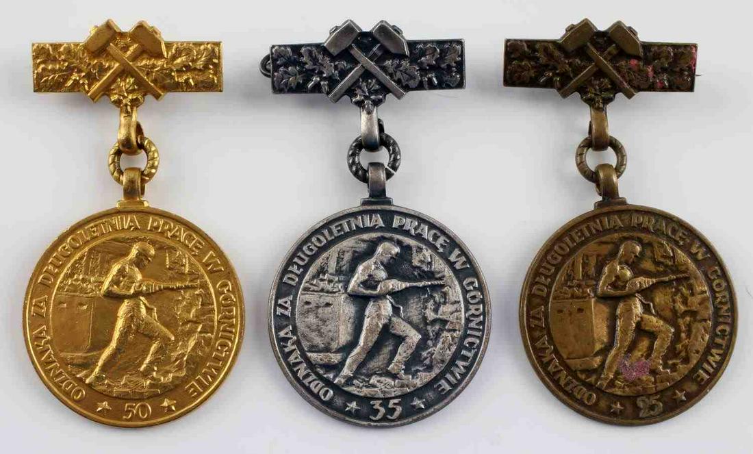 LOT OF 3 POLISH MINING MEDALS FOR LONG SERVICE: Lot of 3 Polish mining medals for long service. 25, 35, and 50 year service medals in this group. Awarded for continuos work in mining. The medals measure approximately 1.5 inches in diameter and 3 in