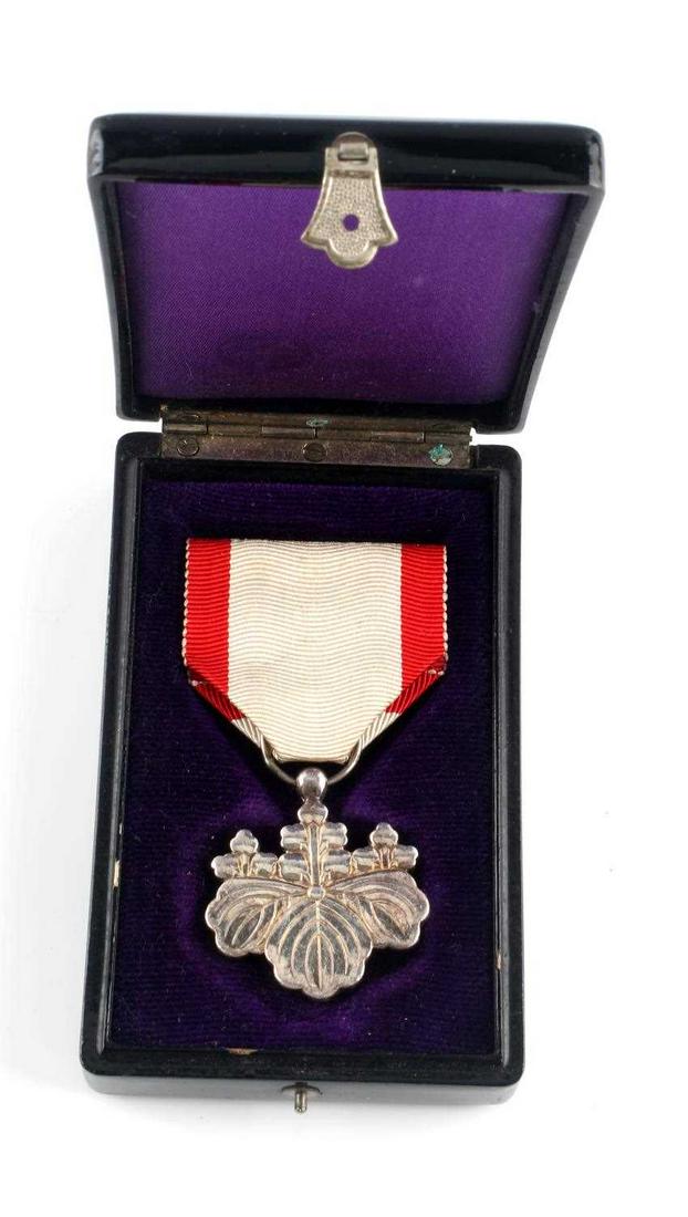 JAPANESE ORDER OF THE RISING SUN MEDAL WITH CASE: Red and white ribbon, flowers and leaves etched design, Japanese characters to reverse. Set in purple felt-lined case. Characters to case exterior as well. Very good condition.