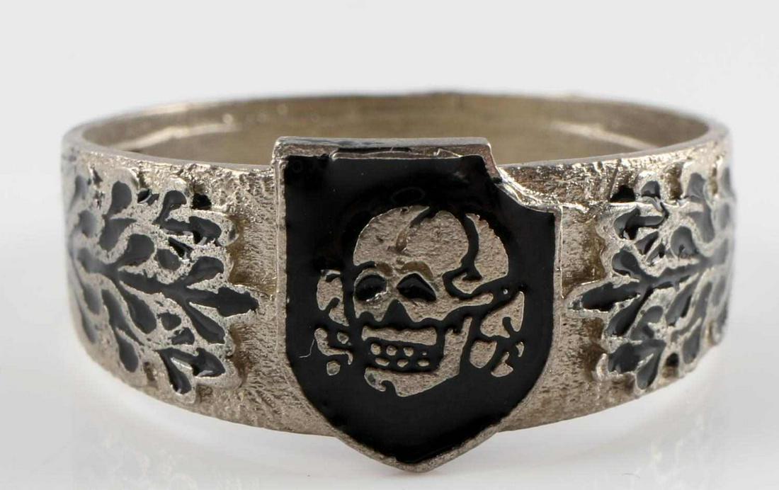 WWII GERMAN REICH WAFFEN SS TOTENKOPF SILVER RING: Size 12. WWII German Waffen "SS" Division "Totenkopf" shield design. Enamel designs. Marked "800". Facsimile "H. Himmler". Tests for silver. Unauthenticated, sold as is. This lot has a reserve.