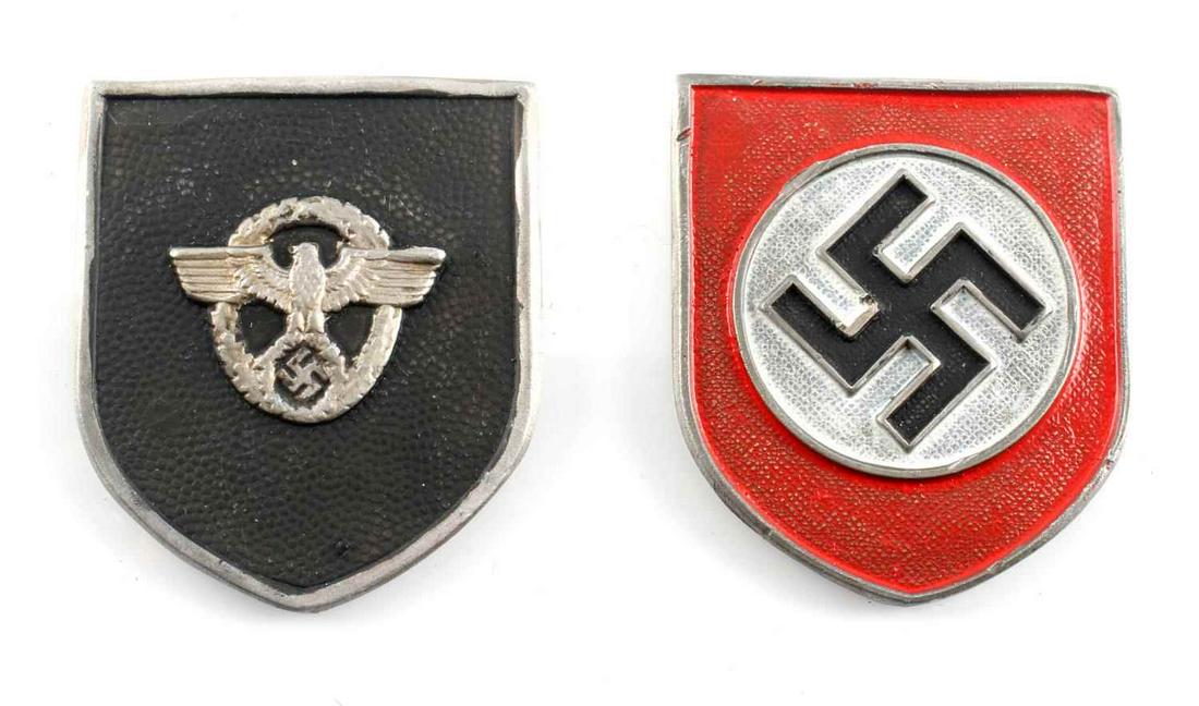 WWII GERMAN REICH SHIELDS FOR TROPICAL PITH HELMET: WWII German Reich 2 shields for tropical pith helmet, each measuring 1 5/8 inches tall by 1 3/8 inches tall. Reverse side on red shield is marked "RZM". Both in good condition. Unauthenticated, sold a