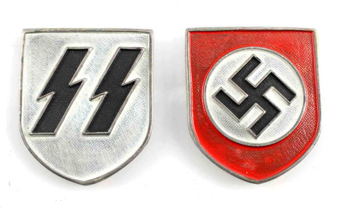 WWII GERMAN REICH 2 SHIELDS FOR SS PITH HELMET: WWII German 2 shields for SS Pith helmet in good condition, each measuring 1 5/8 inches tall by 1 3/8 inches wide . Both in good condition. Reverse side of red shield is marked "RZM". Unauthenticated,