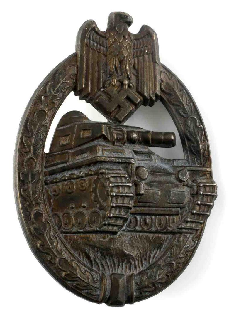 WWII GERMAN ARMY BRONZE ARMY PANZER TANK BADGE: WWII German Army Bronze Panzer Tank Assault Badge. The front shows a tank in the center with a German army eagle clutching a swastika at the top. All three are surrounded by an oval oak leaf wreath. M