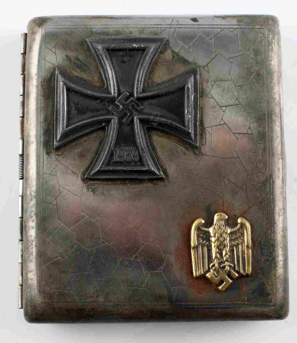 WWII GERMAN REICH IRON CROSS CIGARETTE CASE: WWII German Reich cigarette case with 1939 Iron Cross attached. Case measures 3 11/16 X 3 1/8 inches. Marked on the inside with a Waffenampt eagle, and a "RZM" mark. Has intermittent blemishing throug