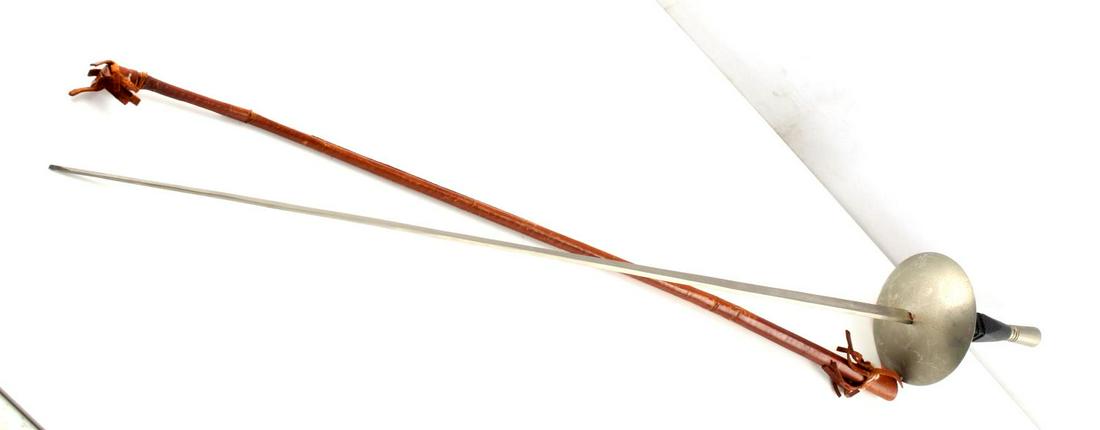 SPANISH TOLEDO FENCING FOIL WITH LEATHER SHEATH: 26 inch 4-sided blade, marked Made in Spain Toledo. Aluminum fittings and wood grip. Leather sheath is torn at end, so foil sticks out.