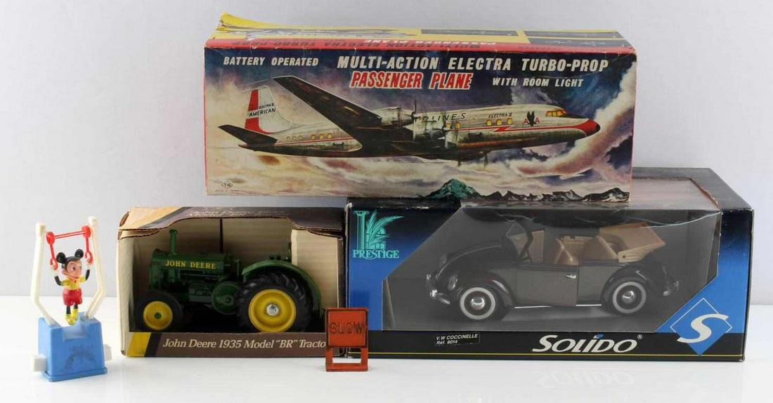 TOY LOT JOHN DEERE AA AIRPLANE VW MICKEY: Scale 1/16 BR Blueprint John Deere tractor, Solido VW Coccinelle, American Airlines battery operated Electra, used but with original box, Mickey mouse string toy, and toy Slow sign.