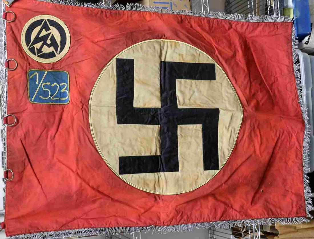 WWII GERMAN THIRD REICH SA STURMABTEILUNG BANNER: Third Reich SA party banner. Likely a restored piece. Features Large swastika with gold trim surrounding it with small SA patch and 7/523 patch. Fringe around border fluoresces. Good condition with st
