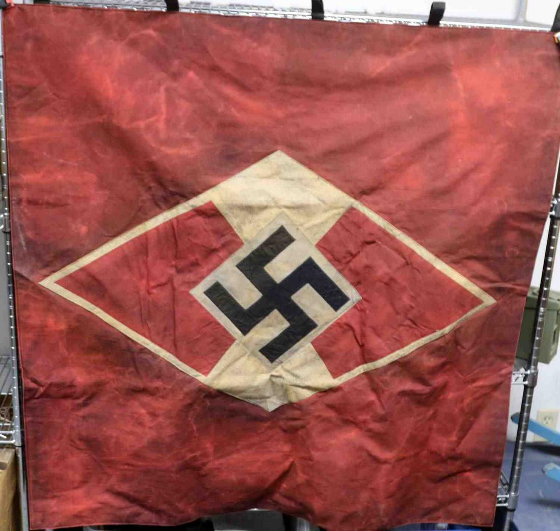 WWII GERMAN THIRD REICH HITLERJUGEND FLAG BANNER: Third Reich Hitlerjugend banner. Multi-piece construction. Features HJ symbol sewn to red banner. Measures approximately 47x47 inches. Good condition with staining. Non-fluorescing.