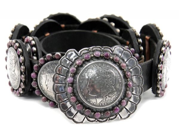 MENS BUFFALO DANCER COIN SILVER CONCHO BELT: A men's concho belt hand crafted by Buffalo Dancer. 1921 Morgan silver dollar and amethyst belt buckle with 12 coin conchos. Each concho has a 1921 Morgan silver dollar surrounded by amethyst. 1 inch 