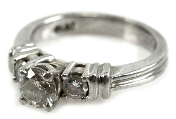 LADIES PLATINUM DIAMOND ENGAGEMENT RING 1 TCW: 0.75 ct brilliant cut diamond with 2 0.125 ct diamonds, 1 on each side. 1 Tcw. Diamonds are approximately SI-1 to SI-2 clarity and H color. . Size: 5.25 . Weight: 7.9g . Condition: Excellent