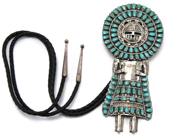 STERLING SILVER TURQUOISE SUNFACE KACHINA BOLO: Navajo Indian Turquoise Sterling Silver Sunface Kachina Bolo Tie. Larry Moses Begay, signed "LMB" to the rear. 5.5 inches. Leather chord with silver finials.