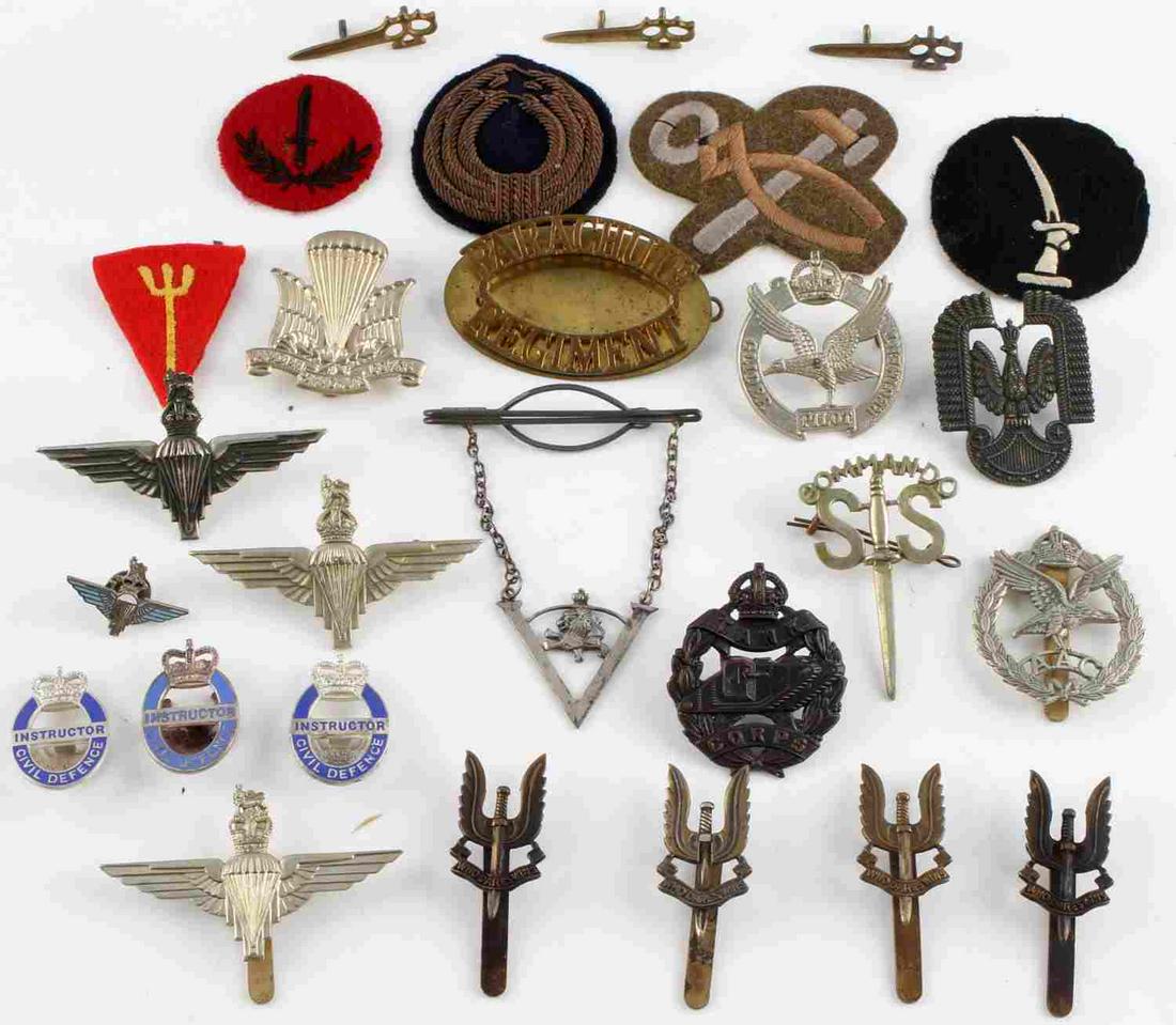 WWII BRITISH EMPIRE LOT OF CAP & BADGE INSIGNIA: WWII British Empire lot of cap & badge insignia including glider pilot badges, parachute & tank corps badges, Special Air Service pins, and many more. In good condition.