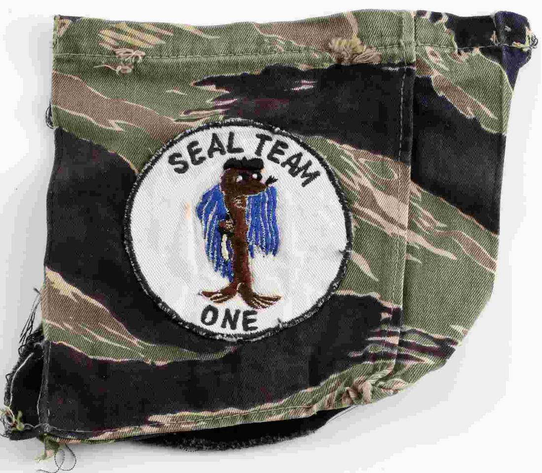 US VIETNAM ERA TIGER STRIPE CUTOUT SEAL TEAM ONE: Vietnam era tiger stripe cutout of SEAL Team One patch. Fabric measures 6 1/4 x 6 3/4 inches. Patch measures 3 1/4 inches. Good condition. This lot has a reserve.