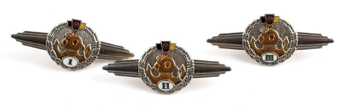 FULL SET OF 3 EAST GERMAN DIVER WINGS: Nickel construction with enamel, screw-on back, and numbered. Measure 2.5 inches wide. Good condition. Unauthenticated, sold as is.