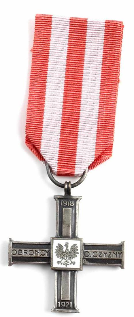 WWII POLISH SILVER CROSS DEFENDER OF FATHERLAND: From the War with the Soviets, 1913 - 1921. Enamel with eagle at center, title and years displayed on obverse, red and pink ribbon. Very good condition. Unauthenticated, sold as is. This lot has a res