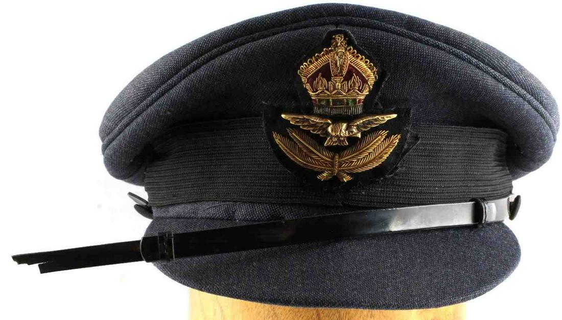 WWII BRITISH ROYAL AIR FORCE PILOTS VISOR CAP: WWII British Royal Air Force pilot's visor cap with bullion embroidered crown on front of cap, as well as a metal eagle insignia. Interior lining of cap in good condition. Does not fluoresce. Unauthen