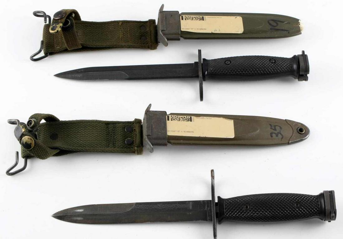 US VIETNAM WAR ERA LOT OF 2 M7 BAYONETS W SCABBARD: US Vietnam war era lot of 2 M7 bayonets with scabbards and frogs. The blades are 6 3/4 inches long with the knife being 11 15/16 inches long in total. Both knives are marked "US M7" & "BOC". Both are 