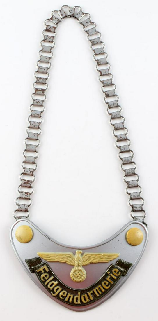 WWII GERMAN THIRD REICH FELDGENDARMERIE GORGET: WWII German Third Reich Feldgendarmerie Gorget. Assman maker on reverse. Chain features oxidation. Gorget measures 6 3/4 x 3 3/4 inches. Chain measures 24 1/2 inches. Magnetic chain and gorget. Paint