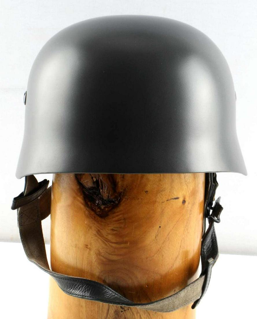 WWII THIRD REICH GERMAN PARATROOPER HELMET: Painted grey steel helmet with leather liner and chinstrap, marked Karl Heister, Berlin C2 DPGM, Kopfweite Gr. 57 Stahlhaube Nr. 69. Very good condition. Unauthenticated, sold as is. This lot has a re