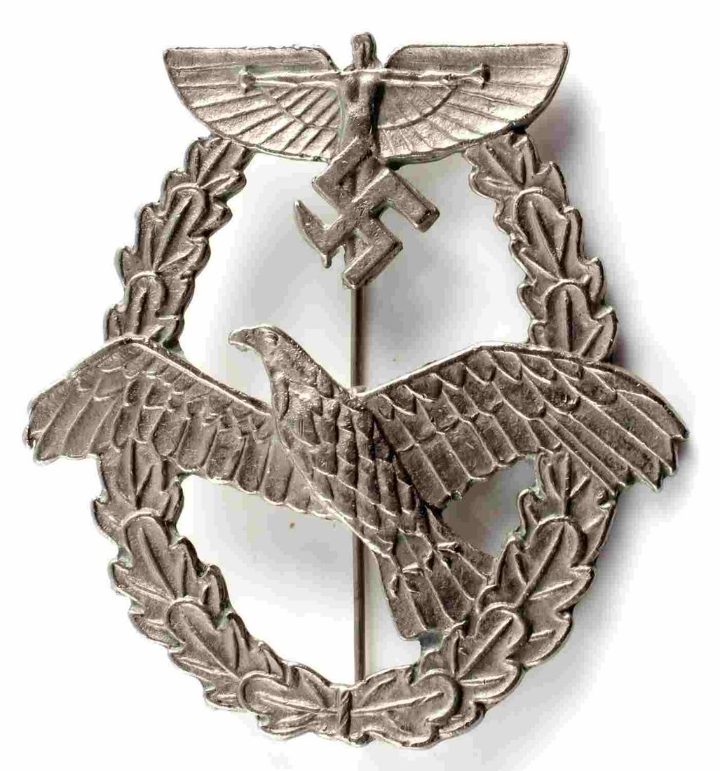 WWII GERMAN THIRD REICH NSFK PILOTS BADGE: WWII German NSFK Pilot's badge. Measures 2 X 2.5 inches and features a vertical 'c' catch hook with a 180 degree pin lie. Unmarked on the reverse. Very good condition overall. Unauthenticated; sold as