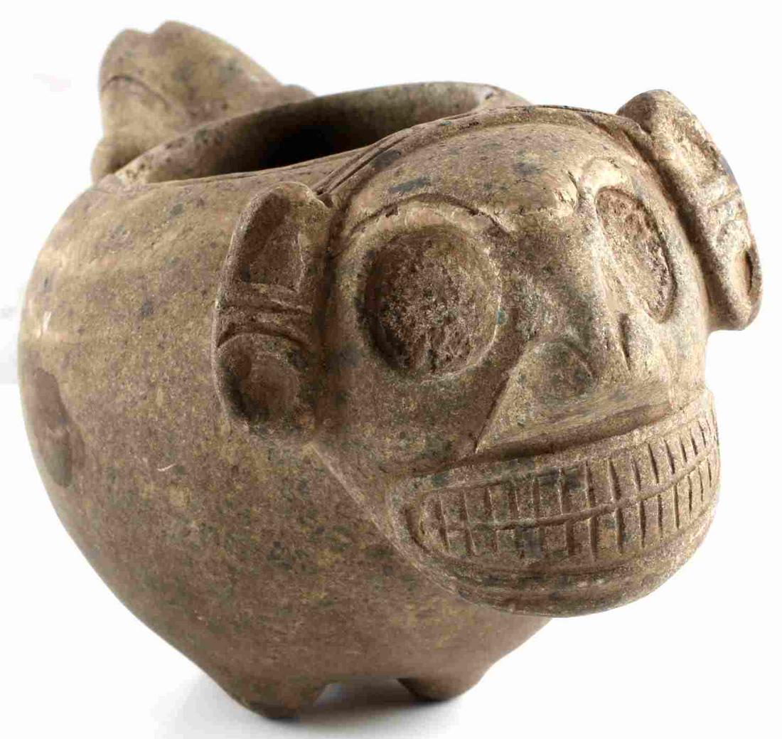 NATIVE AMERICAN TAINO ANTHROPIC COHOBA BOWL: Taino Small Anthropic cohoba bowl with large head with toothy grin. Legs extend from back. Small chip on bowls rim. Curated by Larry Roberts. Andesite. Length 7.6 inches. From the Taino Culture c 1000